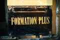 Formation Plus, More Training sign iwth golden letters