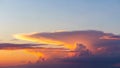 Dramatic lenticular cloud formation illuminated by golden sunset light against a clear blue sky creating a natural Royalty Free Stock Photo