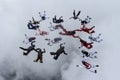 Formation skydiving in the cloudy sky. Royalty Free Stock Photo