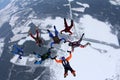 Formation skydiving. A group of skydivers are doing a figure in the sky.