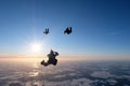 Formation skydiving. Skydivers are doing a figure in the sky.