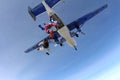 Formation skydiving. Skydivers are jumping out of an airplane into the sky.