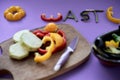 formation of the word zero waste with pieces of vegatal next to a wooden board and a container full of vegetables Royalty Free Stock Photo