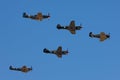 Formation of World War II fighter aircraft comprising a CAC Boomerang, two P-40 Kittyhawks a P-51 Mustang and a Supermarine Spitfi