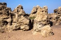 Formations of Weathered Rock Against Blue Sky on Beach Royalty Free Stock Photo