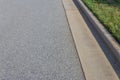 Formed concrete curb with green grass, asphalt copy space Royalty Free Stock Photo