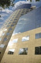 Former Bancorex building in Bucharest with modern curved architecture and reflective glass faÃ§ade under a bright sky Royalty Free Stock Photo