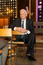 Former Federal President Joachim Gauck sits sideways on a chair in St. Josef Church in Cloppenburg