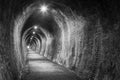 Old brick tunnel, lit up with electric lights. Black and white Royalty Free Stock Photo