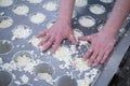 Forming pressing of cheese mass. Cheese grains about 6 mm in size in molding glasses