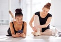 Forming strong bonds with my team. two ballet dancers taking a break while using a smartphone.