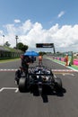 Formula car in motor sport circuit pole position rear view