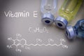 Formula Chemical Vitamin E together with different vials Royalty Free Stock Photo