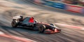 Formula One race. Black racing car driving on track. Motion blur from long exposure Royalty Free Stock Photo