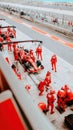 Formula 1 pit stop with red racing team working on car during race Royalty Free Stock Photo