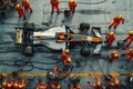 Formula 1 pit stop. technical team performing high-speed maintenance on racing car Royalty Free Stock Photo