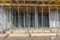 formwork - metal poles supporting the slabs on which concrete will be poured to make the ceiling in the building Royalty Free Stock Photo