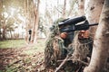 Forrest men, aim paintball gun and trees for outdoor war game, strategy or focus in natural camouflage. Sniper, army Royalty Free Stock Photo