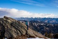 Forstalpe - Woman with a hiking backpack next to massive rock on summit Gertrusk near Ladinger Spitz Royalty Free Stock Photo