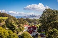 Fort baker and tall trees in the foreground and the San Francisco skyline and the bay bridge in the background Royalty Free Stock Photo