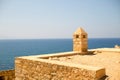 Fort castle with a tower from pirimindalnoy roof high above the azure sea