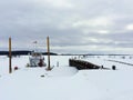 Fort Chipewyan, Alberta, Canada - March 17th, 2016: A boat docked during the winter, surrounded by nothing but an endless vast ho