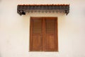 Wooden window on the white wall of an old heritage house in the historic town of Fort Royalty Free Stock Photo