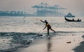 Fort Kochi fisherman throwing his net into the water india Royalty Free Stock Photo