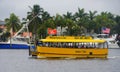 Fort Lauderdale, Florida, U.S.A - December 28, 2019 - Yellow water taxi carrying passengers on the canal