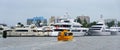 Fort Lauderdale, Florida, U.S.A - December 28, 2019 - Yellow water taxi and luxury boat on the canal
