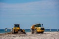 Construction machines cleaning up Fort Myers Beach after Hurricane Ian