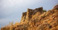 Fort ruins at Tzia, Kea island, Greece. Under view of red stonewall of ancient castle background