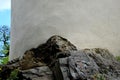 Fortification wall on a rocky cliff top. round building with white old plaster. naval lighthouse. the rock penetrates inside the w