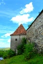 Fortified saxon evangelic church. Typical rural landscape and peasant houses in the village Drauseni, Transylvania, Romania.