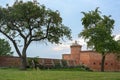 Fortified tower and wooden walkway on the ramparts with trees and lawn of the historic fortress of Domitz on the river Elbe in