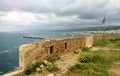 The fortified wall of the town of Rethymno on the island of Crete against the background of sea and city view. Royalty Free Stock Photo