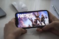 Fortnite game on the iPhone screen.