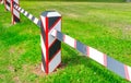 Fortress military wooden border fence barrier with post on green grass lawn