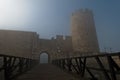 Fortress tower, gate and wooden bridge in fog at autumn sunny morning, Kalemegdan, Belgrade Royalty Free Stock Photo