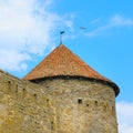 Fortress tower with tiled roof on blue sky Royalty Free Stock Photo