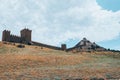 A fortress with towers on a rock.