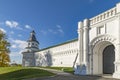 Fortress wall with gate and watchtower.