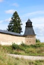 Fortress wall and tower of Pskov-Pechory Dormition Monastery in Pechory, Pskov region, Russia under blue sky Royalty Free Stock Photo