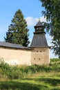 Fortress wall and tower of Pskov-Pechory Dormition Monastery in Pechory, Pskov region, Russia under blue sky Royalty Free Stock Photo