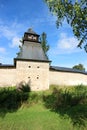 Fortress wall and tower of Pskov-Pechory Dormition Monastery in Pechory, Pskov region, Russia under blue sky Royalty Free Stock Photo