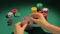 Fortunate poker player checking cards, getting chance to win game with two aces