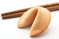 Fortune cookie and brown chopsticks on white