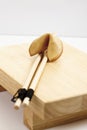 Fortune cookie and chopsticks on wooden board Royalty Free Stock Photo