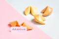 fortune cookie on pink and blue background, pastel colors, adventure prediction