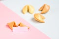 fortune cookie on pink and blue background, pastel colors, copy space